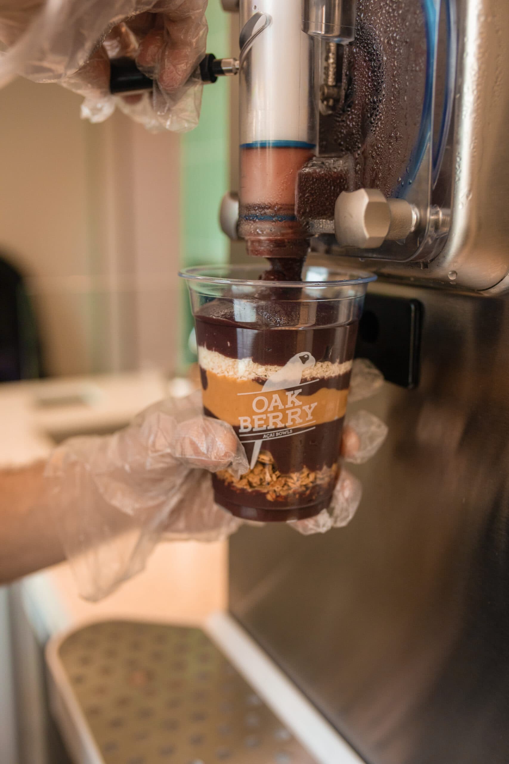 A employee pouring a Açaí into a Bowl