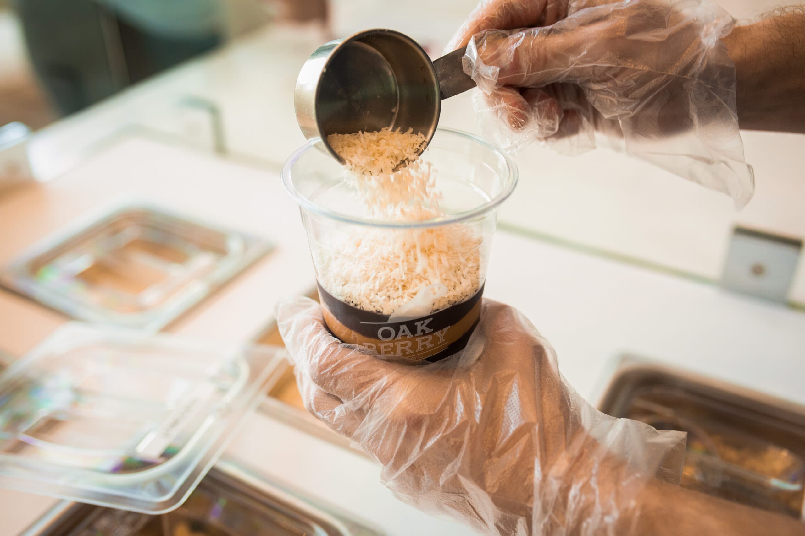 an employee assembling an OAKBERRY Bowl